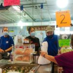Debbie Duong, left and Steve Nguyen, right, serve customers as store manager Samantha Tran, center, chats with customer Jan Larsen at Rose's Seafood market in Seabrook.