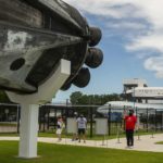 Visitors look at the new display of a SpaceX Falcon 9 rocket on display, Sunday, July 19, 2020, at Space Center Houston. The booster served on two NASA missions. The popular attraction next to NASA's Johnson Space Center re-opened to the general public on Sunday for the first time since closing its doors amidst the COVID-19 pandemic. Numerous new procedures have been put into place to keep guests and staff safe.
